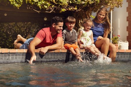 Happy Family playing in pool