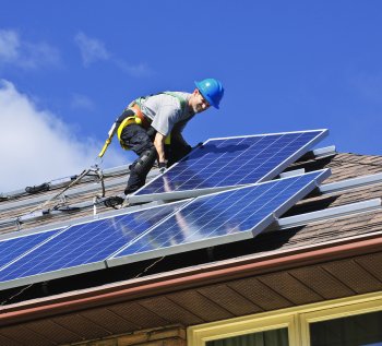 Worker installing solar panels