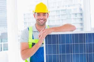 A working professional standing with a solar panel