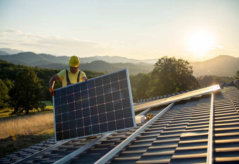 Technician fitting solar panel