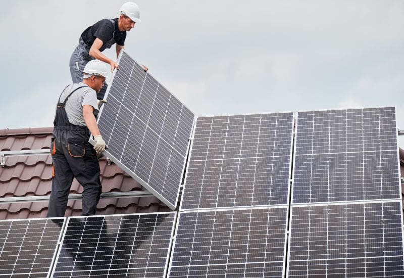 Technicians installing solar panels