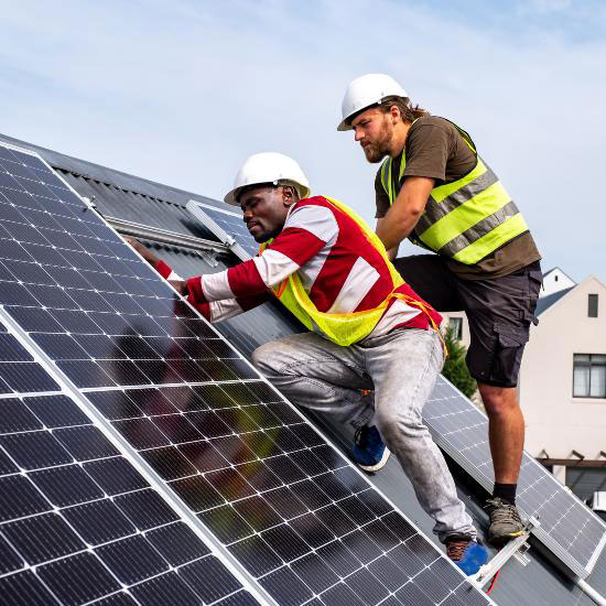 technicians on roof installing solar panels