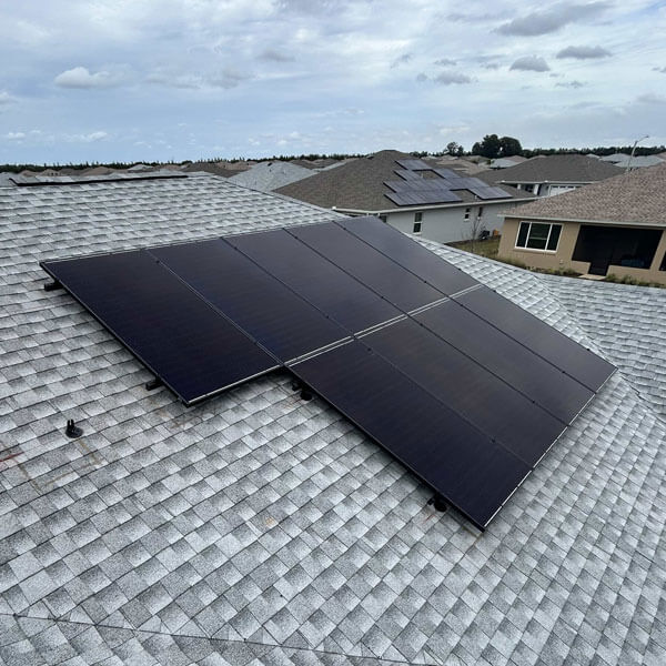 PV solar electric panels on residential roof in neighborhood